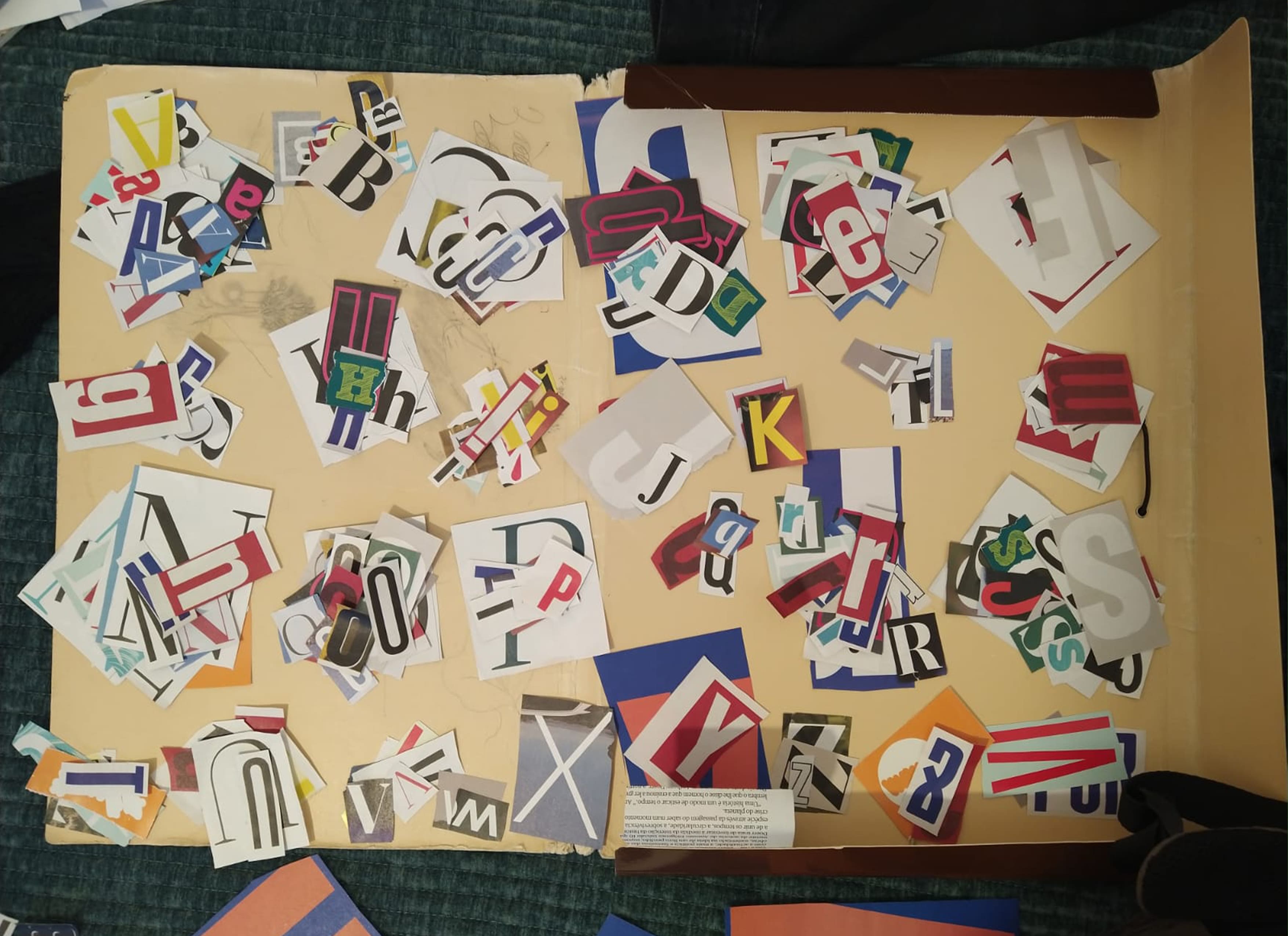 Scanned image of a series of paper cutouts of diifferent letters, grouped alphabetically.