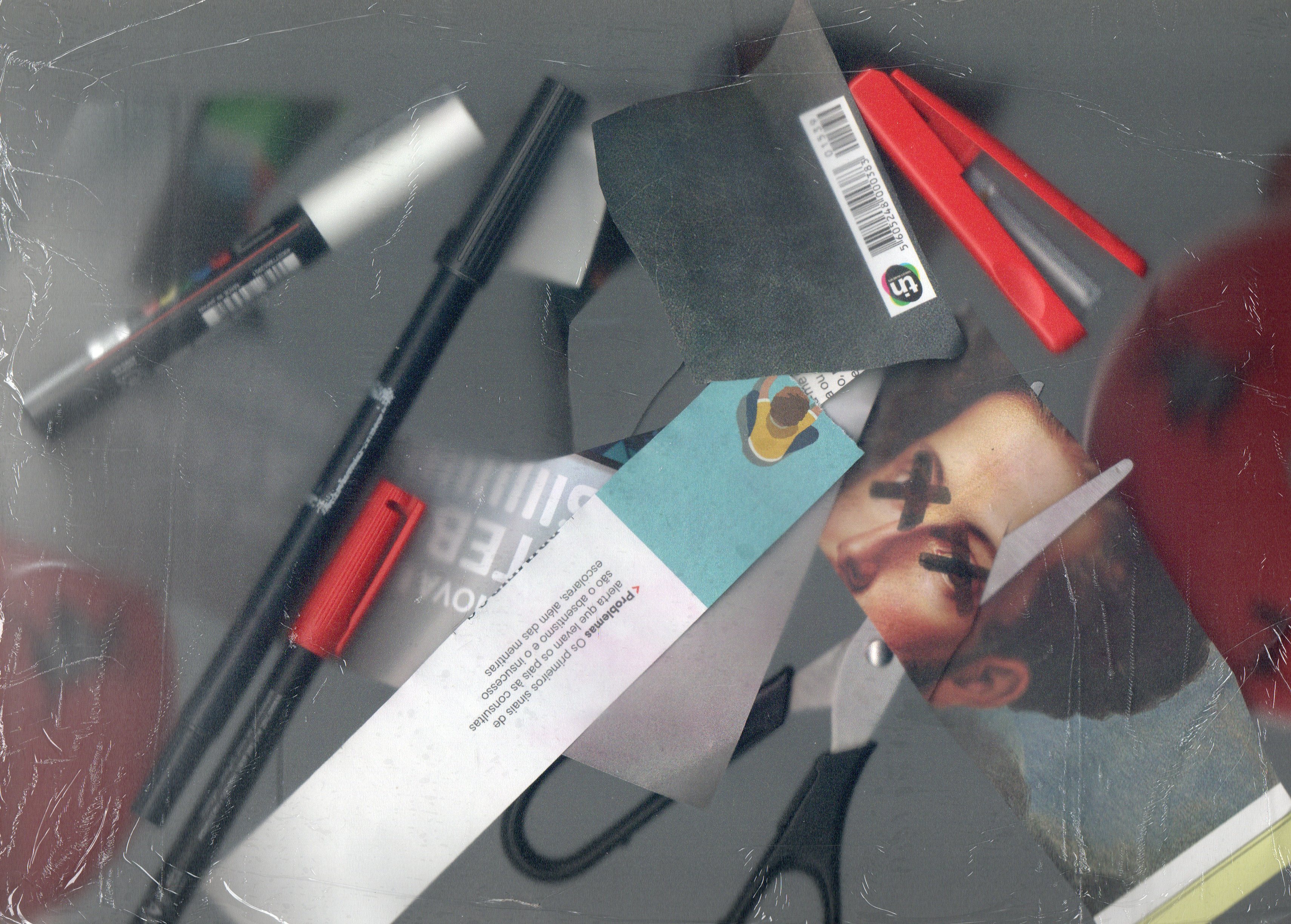 Scanned image of a series of overlapped paper cutouts and objects, such as scissors and pens.